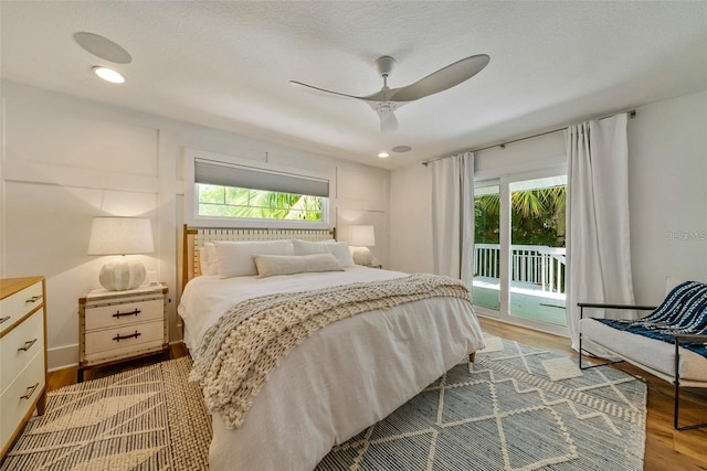 bedroom featuring access to exterior, ceiling fan, and wood-type flooring