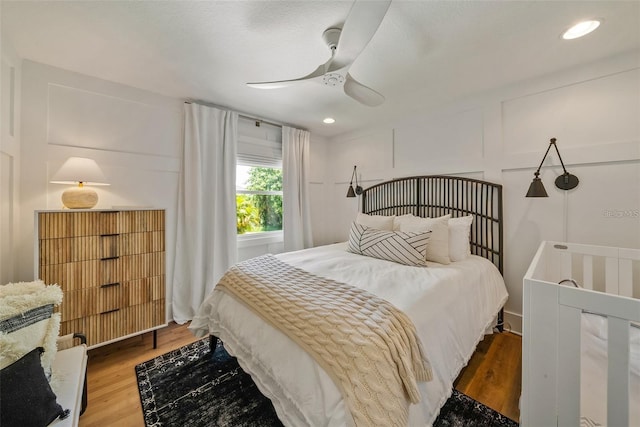 bedroom featuring hardwood / wood-style floors and ceiling fan