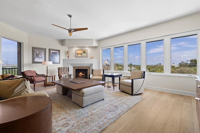 living room with ceiling fan and light hardwood / wood-style floors