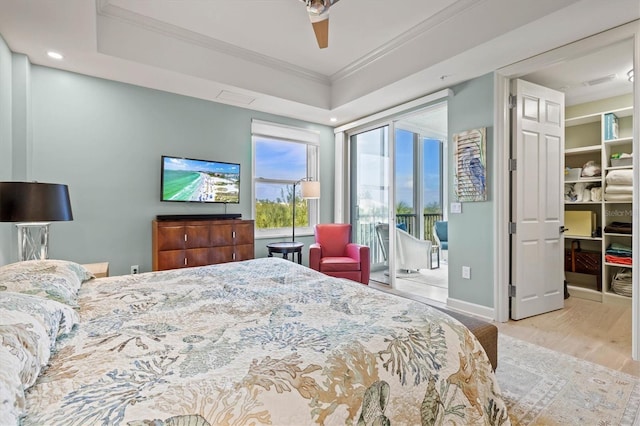 bedroom with light wood-type flooring, ceiling fan, and ornamental molding