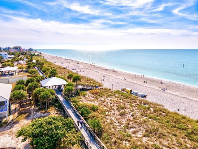 drone / aerial view featuring a water view and a beach view