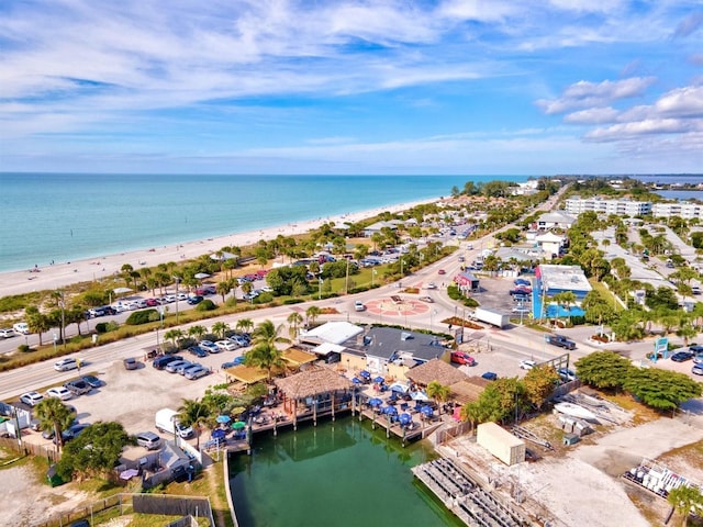 drone / aerial view featuring a water view and a beach view