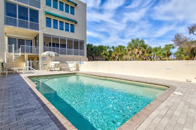 view of swimming pool featuring a patio