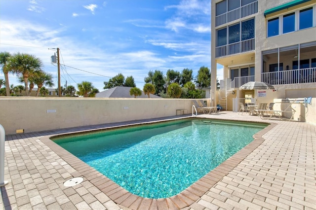 view of swimming pool with a patio area