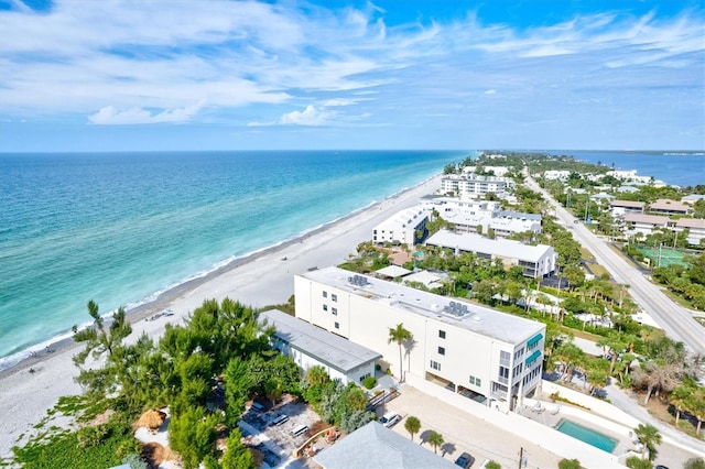 drone / aerial view with a water view and a beach view