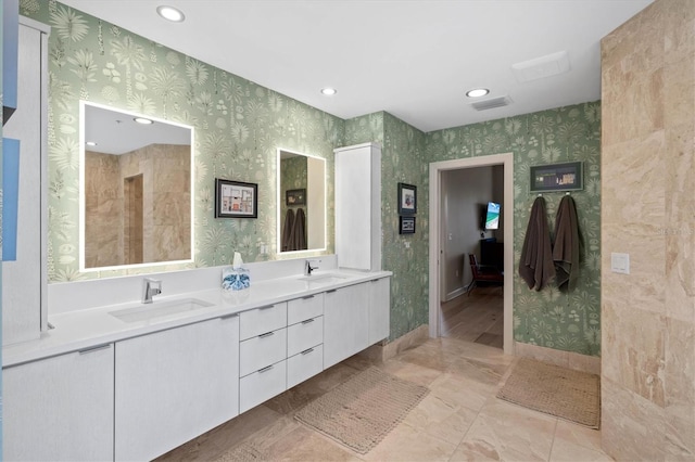 bathroom featuring tile patterned flooring and vanity