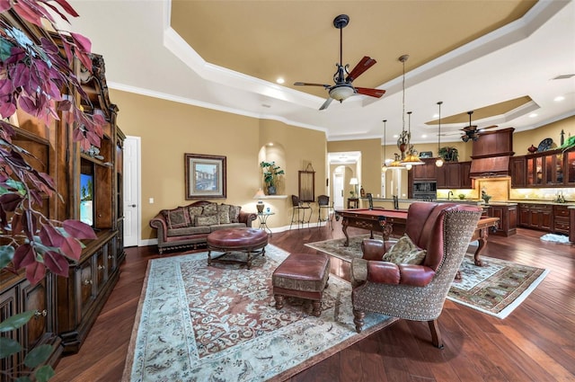 living room featuring dark hardwood / wood-style flooring, ornamental molding, a raised ceiling, and billiards