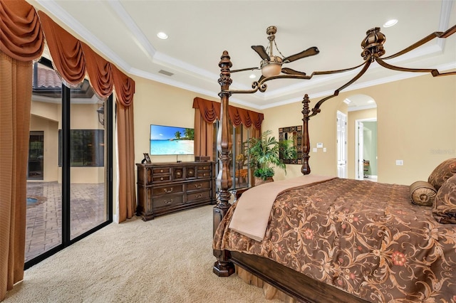 carpeted bedroom with crown molding, access to outside, and a raised ceiling