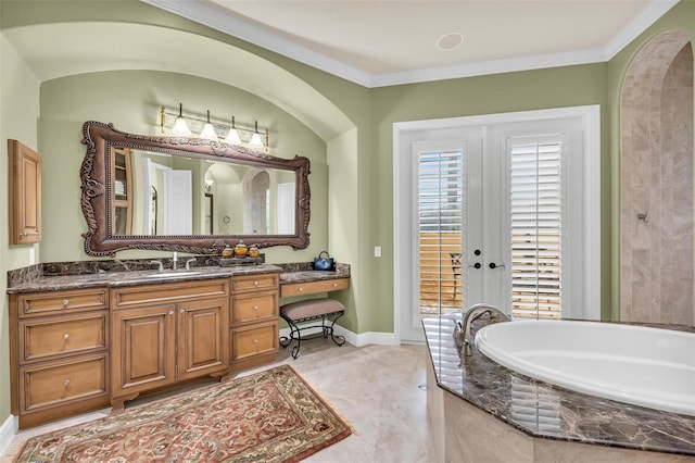 bathroom featuring tile patterned flooring, ornamental molding, vanity, tiled tub, and french doors