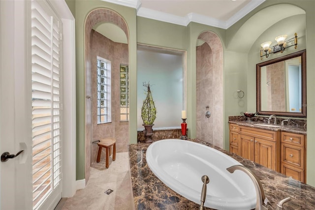 bathroom with vanity, tiled tub, and crown molding