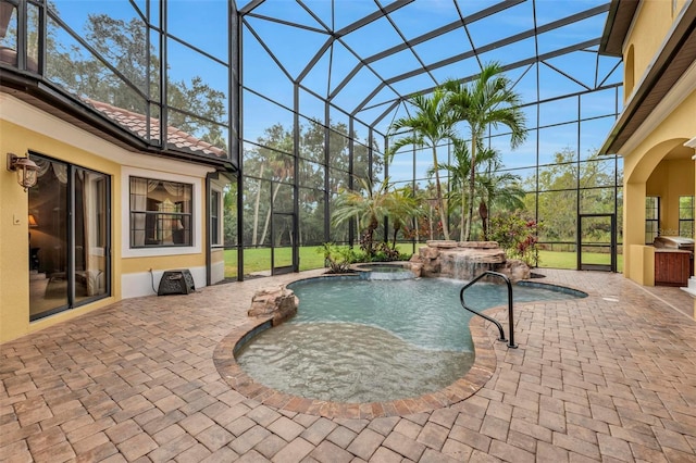 view of swimming pool featuring area for grilling, a lanai, a patio area, and an in ground hot tub