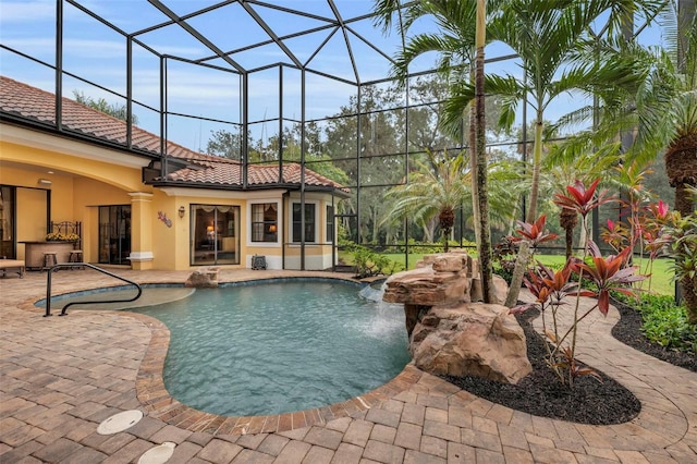 view of swimming pool with pool water feature, a lanai, ceiling fan, and a patio area