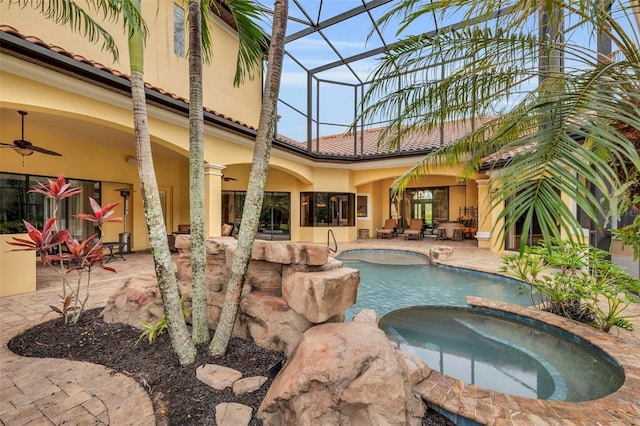 view of pool with an in ground hot tub, a lanai, ceiling fan, and a patio area