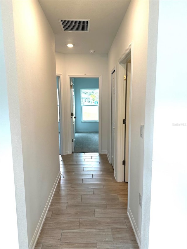 corridor with light wood-type flooring