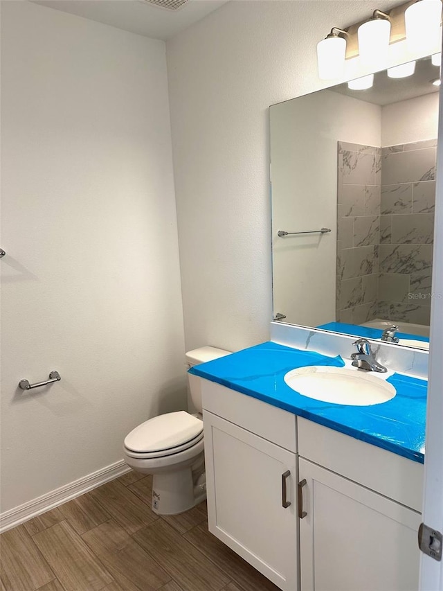 bathroom featuring hardwood / wood-style floors, vanity, and toilet