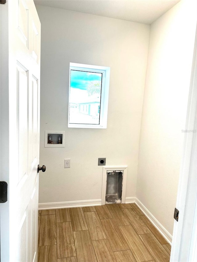 laundry room with hookup for an electric dryer, washer hookup, and light wood-type flooring