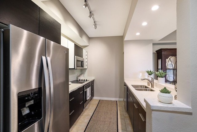 kitchen featuring sink, light stone countertops, light tile patterned floors, tasteful backsplash, and stainless steel appliances