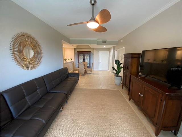 living room featuring ceiling fan, light tile patterned flooring, and crown molding