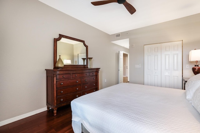 bedroom with a closet, ceiling fan, and dark hardwood / wood-style flooring