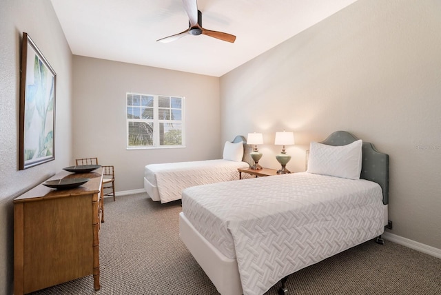 bedroom featuring ceiling fan and dark carpet