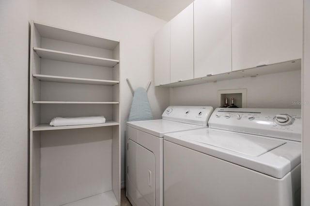 laundry area featuring cabinets and separate washer and dryer