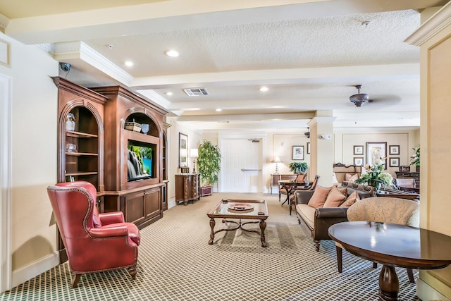 interior space with ceiling fan, a textured ceiling, and ornamental molding