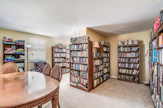 carpeted office featuring a textured ceiling