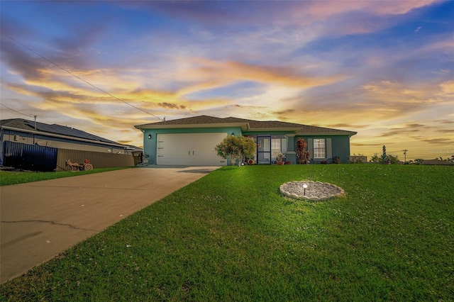 ranch-style house featuring a lawn and a garage