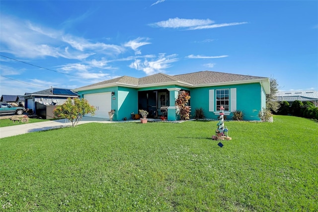 ranch-style house featuring a garage and a front lawn