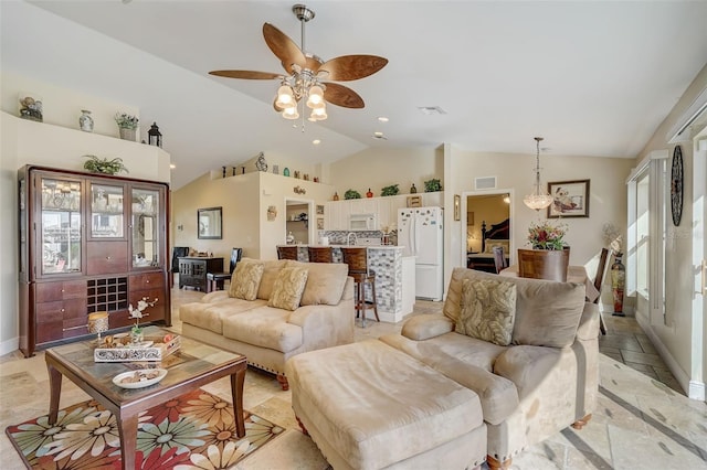 living room featuring ceiling fan and vaulted ceiling