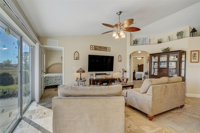 living room featuring ceiling fan and lofted ceiling