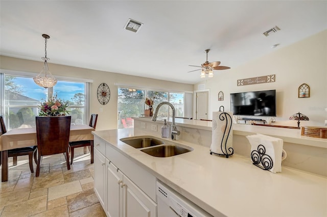 kitchen featuring dishwasher, white cabinets, sink, hanging light fixtures, and ceiling fan