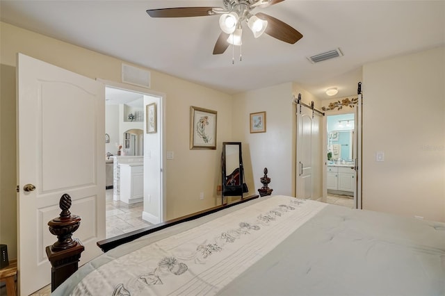 bedroom featuring ensuite bath and ceiling fan