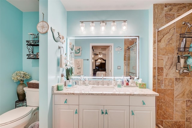 bathroom with vanity, toilet, and a shower with shower door