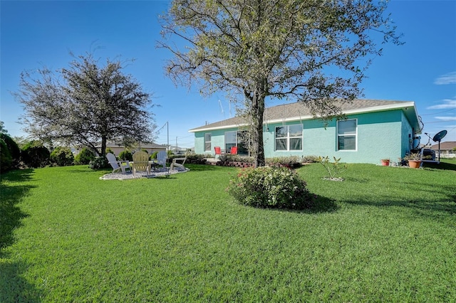 rear view of property featuring a yard