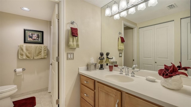 bathroom featuring tile patterned flooring, vanity, and toilet