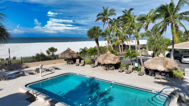 view of swimming pool featuring a gazebo, a water view, and a patio