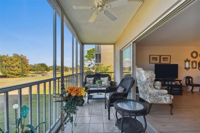 sunroom / solarium featuring ceiling fan