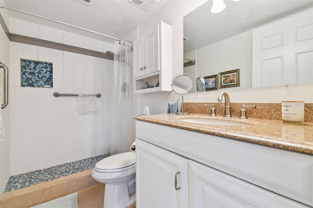 bathroom with tile patterned flooring, vanity, curtained shower, and toilet