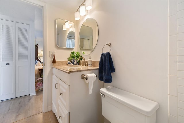 bathroom featuring tile patterned flooring, vanity, and toilet