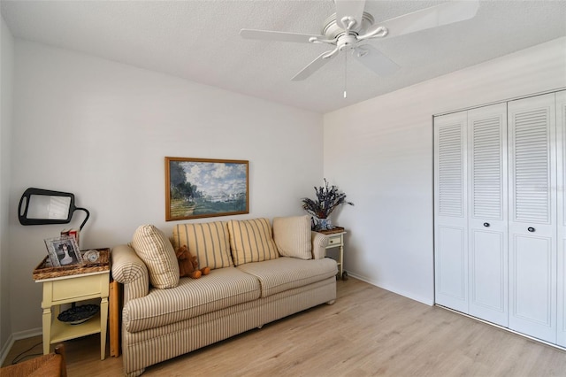 living room featuring ceiling fan and light wood-type flooring