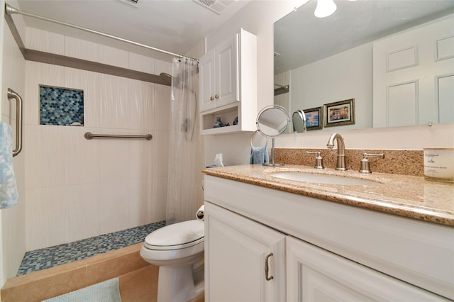 bathroom featuring a shower with shower curtain, vanity, and toilet