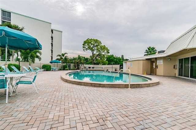 view of swimming pool with a patio