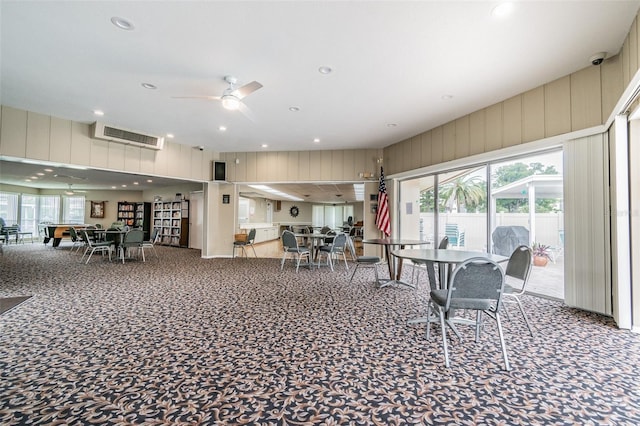 carpeted dining space with ceiling fan