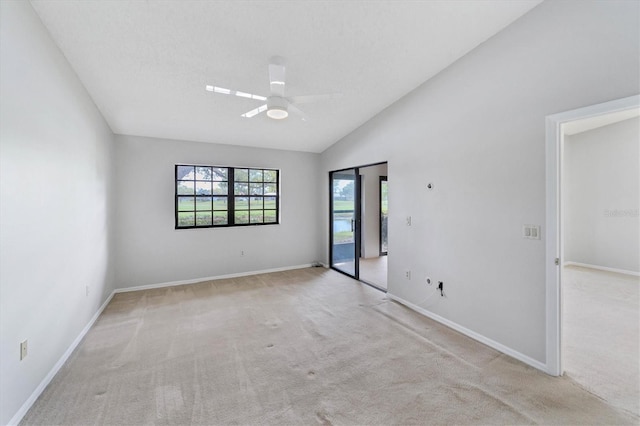 empty room with light carpet, ceiling fan, and lofted ceiling