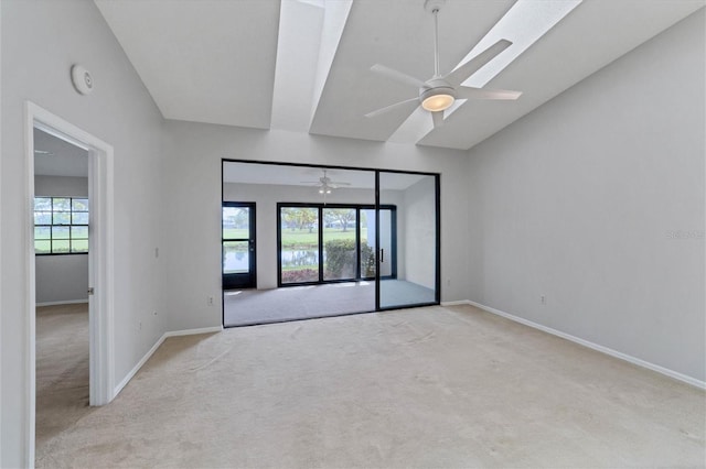 spare room with ceiling fan and light carpet