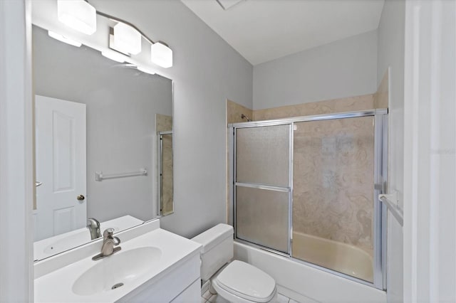 full bathroom featuring shower / bath combination with glass door, vanity, toilet, and tile patterned flooring