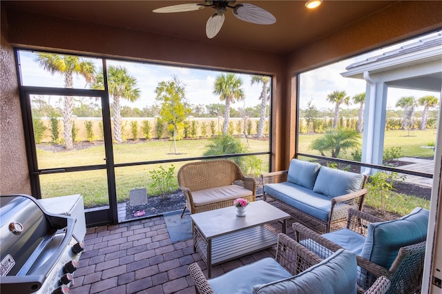 sunroom with ceiling fan