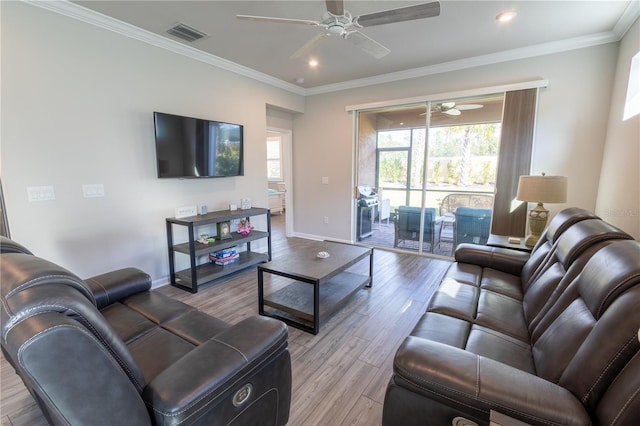 living room featuring ceiling fan, crown molding, and light hardwood / wood-style floors