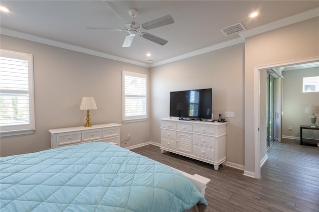 bedroom featuring dark hardwood / wood-style floors, ceiling fan, and crown molding